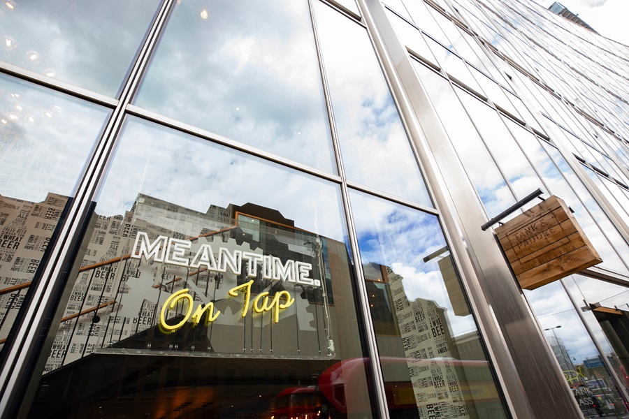 A window with a sign saying meantime on tap