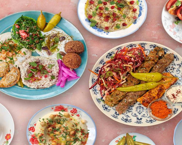 A variety of Lebanese style food items on plates.
