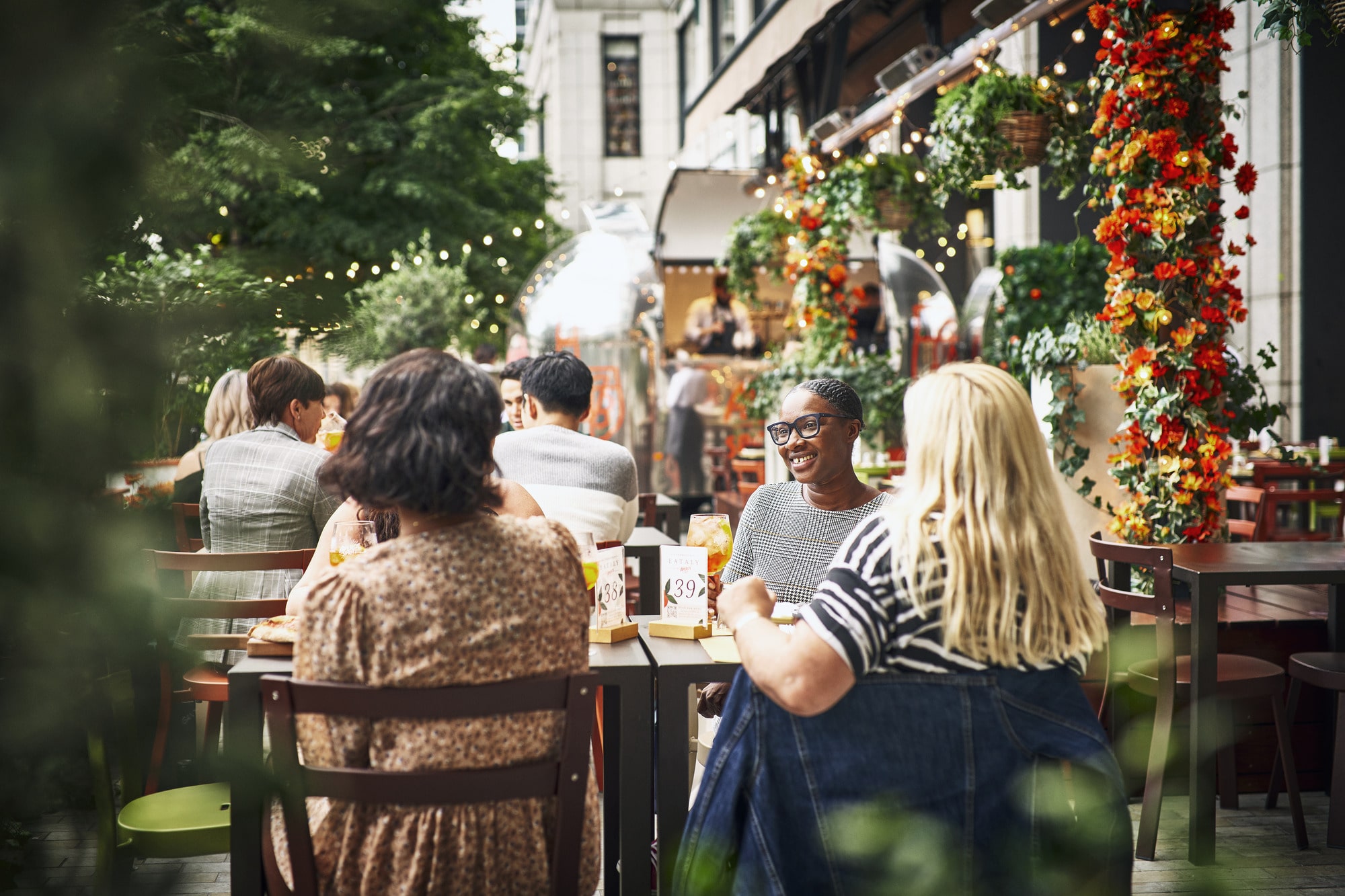 Friends sit together in the external seating area at Eataly